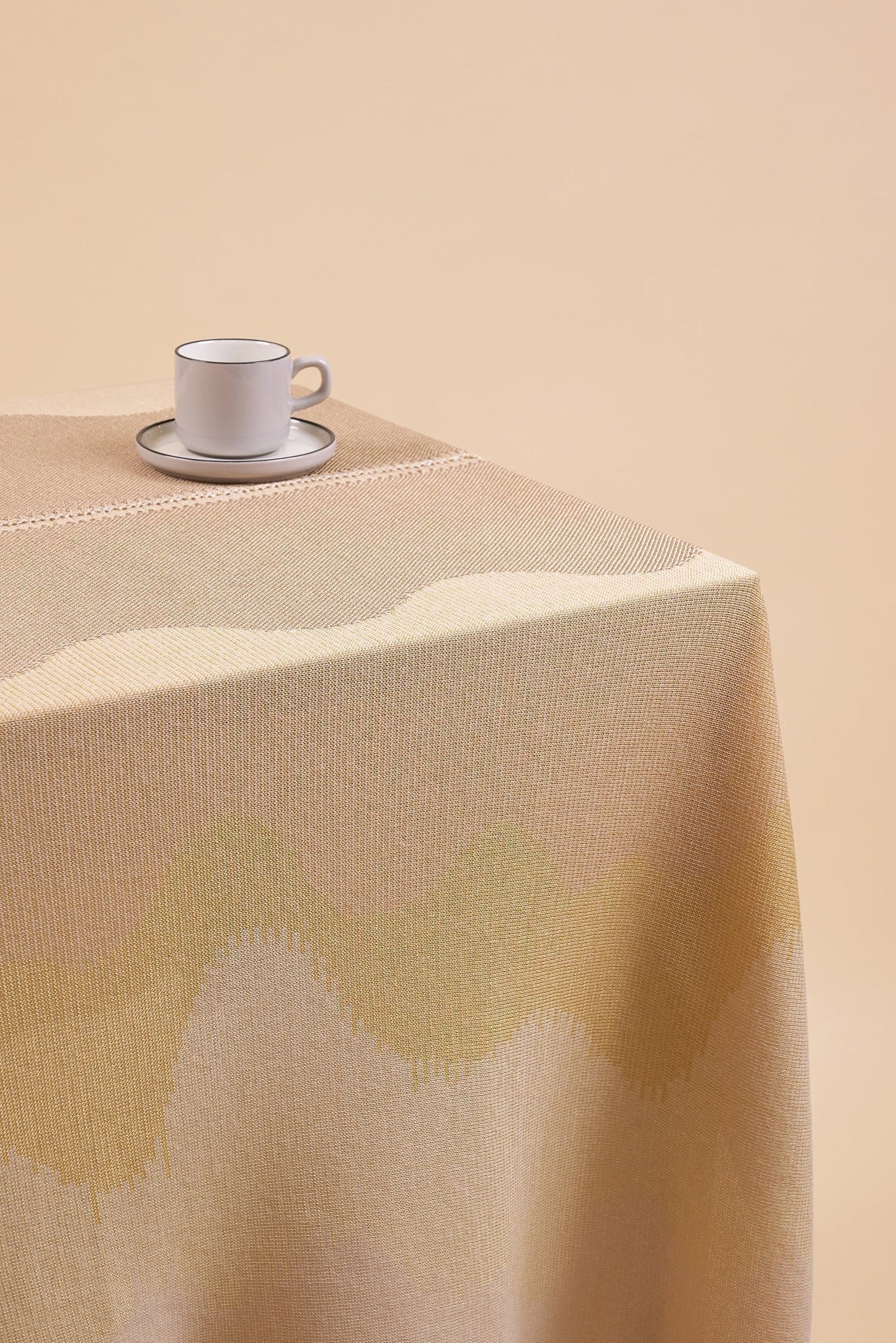 close-up of organic cotton knit tablecloth with hand-stitched seam in yellow monochrome tones