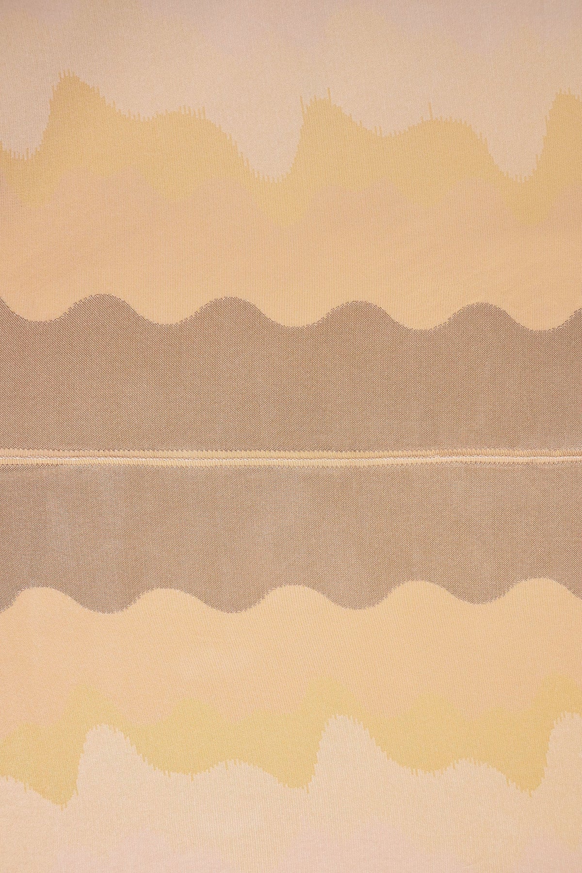 top view detail of organic cotton knit tablecloth with hand-stitched seam in yellow monochrome tones