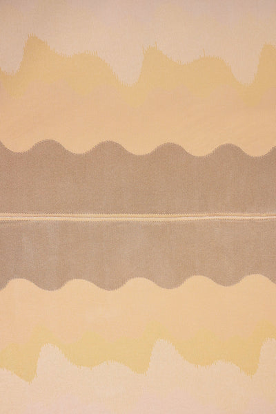 top view detail of organic cotton knit tablecloth with hand-stitched seam in yellow monochrome tones