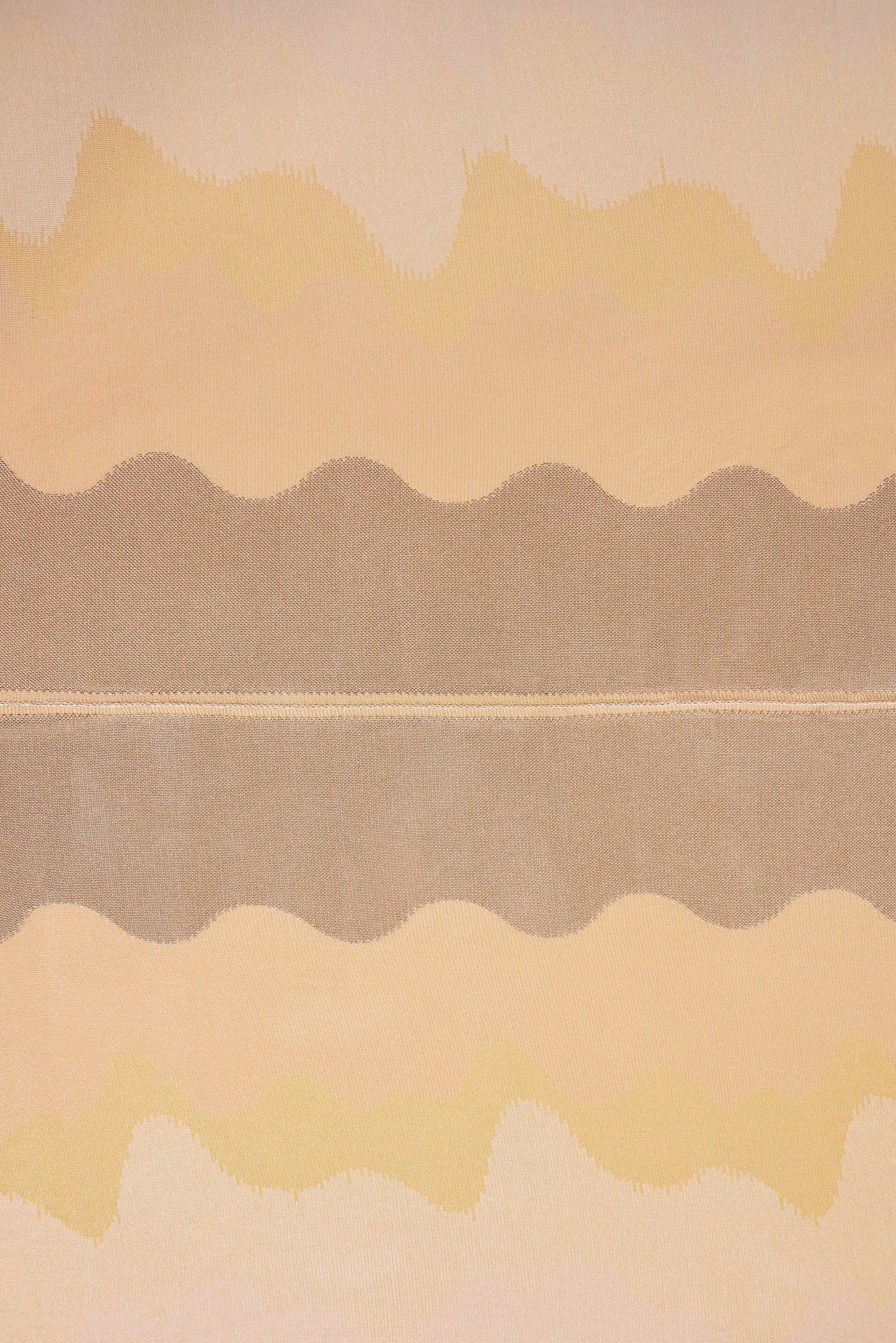 top view detail of organic cotton knit tablecloth with hand-stitched seam in yellow monochrome tones