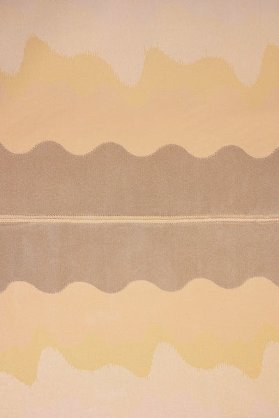 top view detail of organic cotton knit tablecloth with hand-stitched seam in yellow monochrome tones