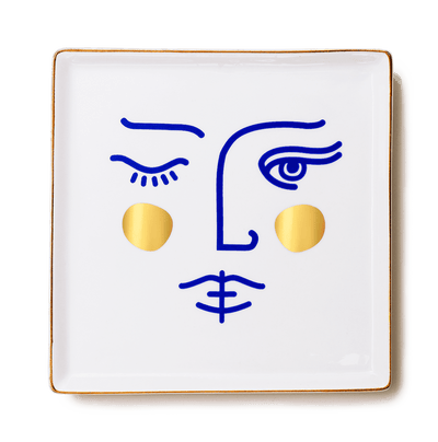 OCTAEVO Janus Goddess Ceramic Tray: square white ceramic with minimalist blue face and gold circle cheeks.