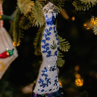 A blue and white sequinned ornament tequila on a Christmas tree