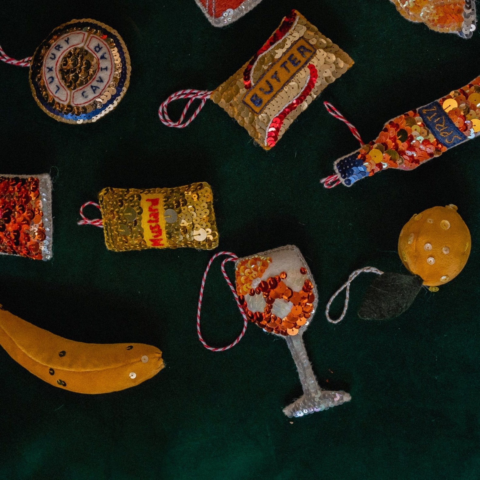 A collection of yellow and orange sequin ornaments in a flat lay