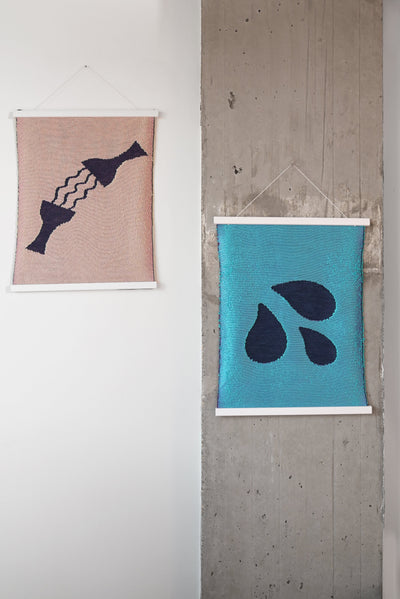 front view of blue knit wall hanging with wooden magnetic frame displayed