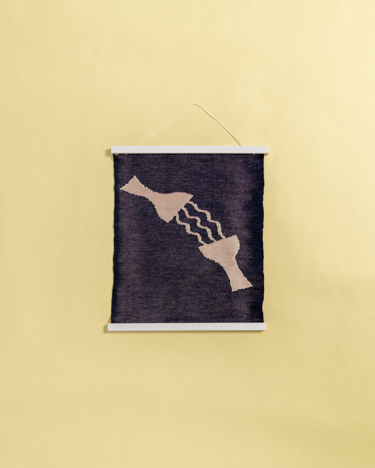back view of pink knit wall hanging in with wooden magnetic frame
