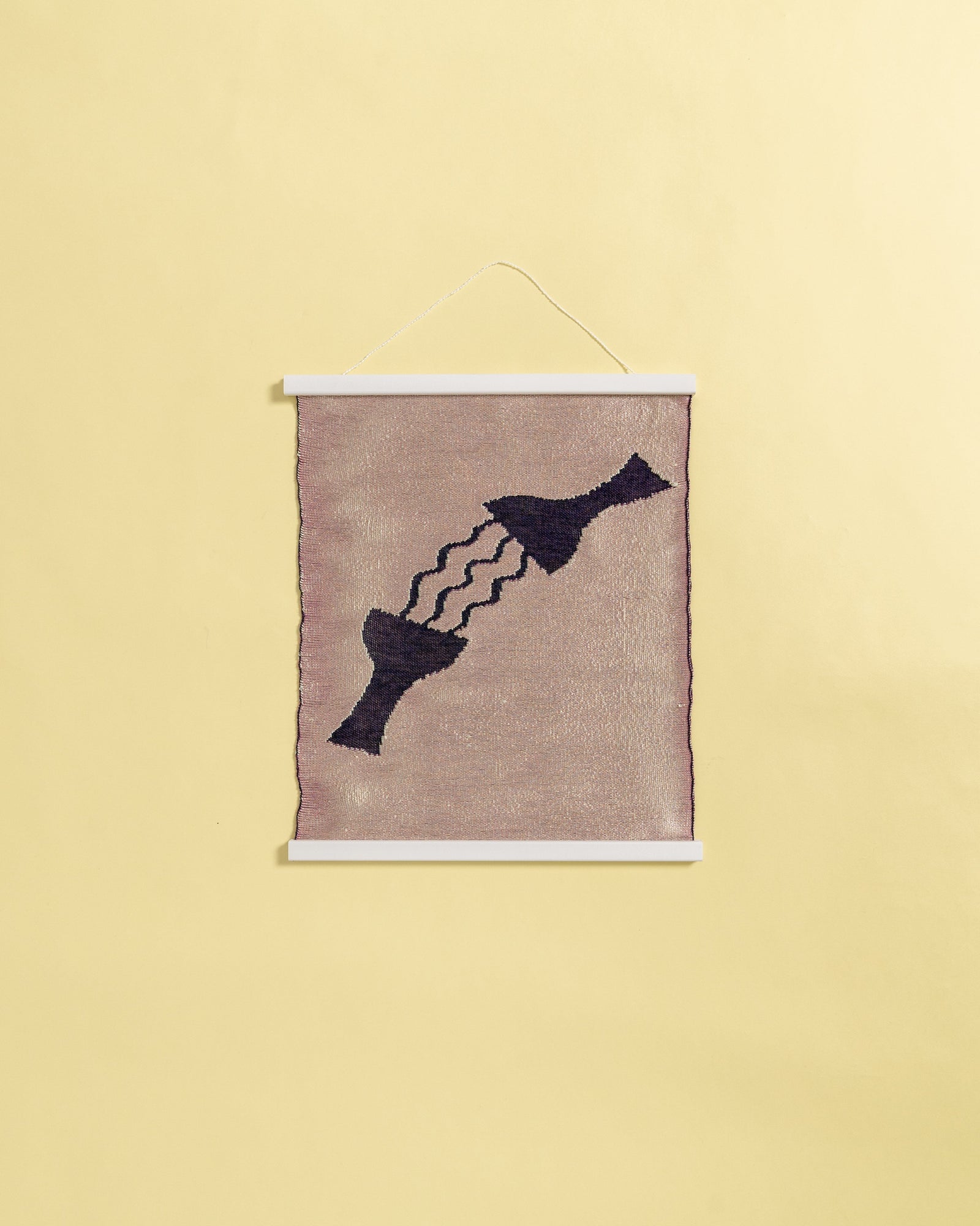 front view of pink knit wall hanging in with wooden magnetic frame on background
