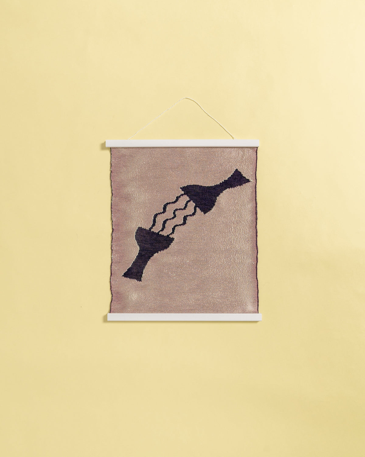 front view of pink knit wall hanging in with wooden magnetic frame on background

