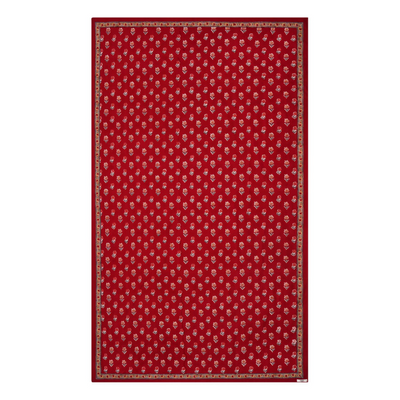 A red floral block printed tablecloth with a border