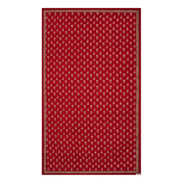 A red floral block printed tablecloth with a border