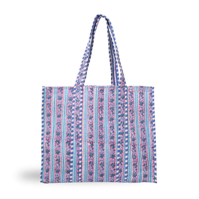A stylish printed cotton tote bag with a striped botanical design in pinks, blues and purples
