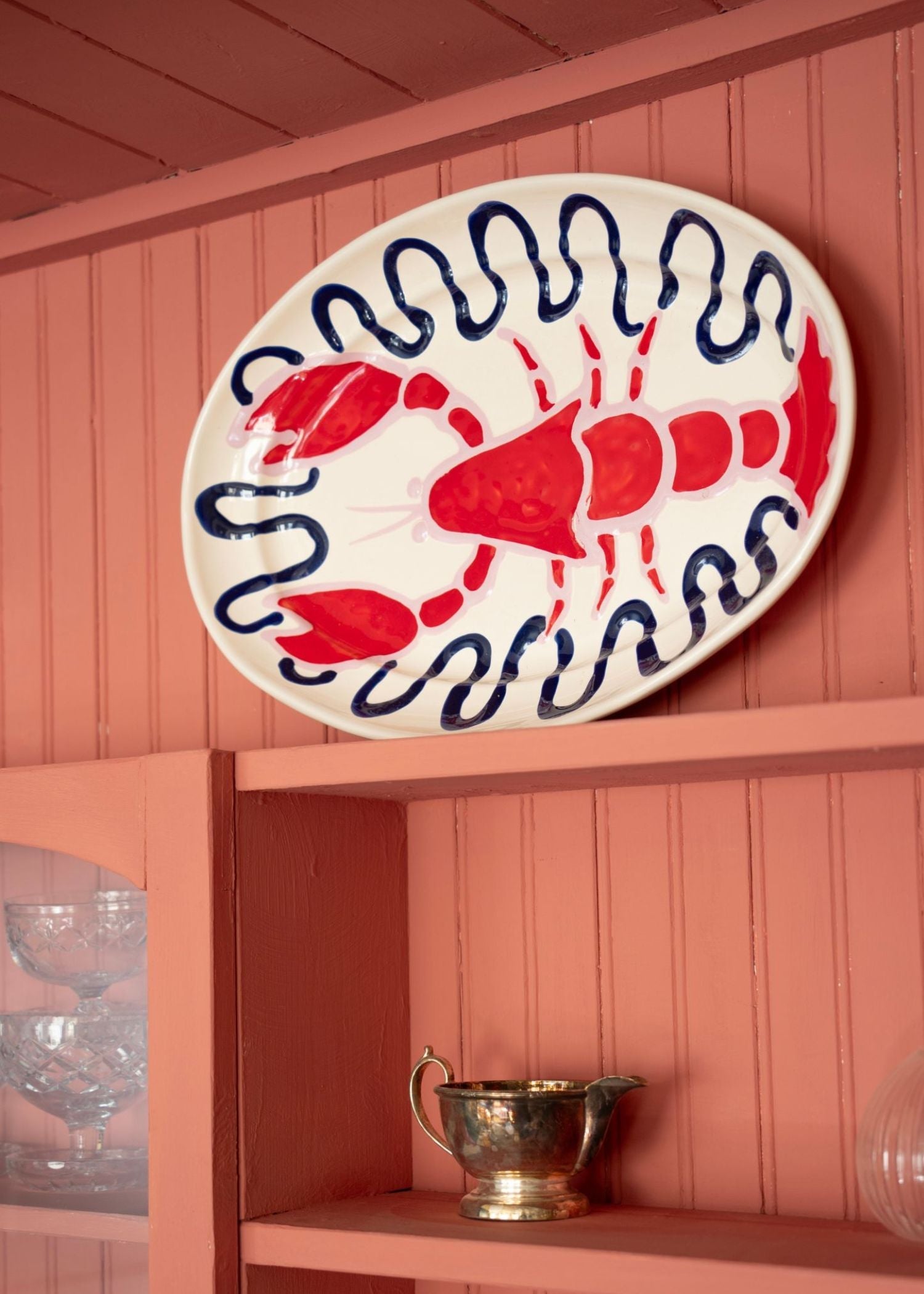 Lobster ceramic by Amuse La Bouche on pink cabinet
