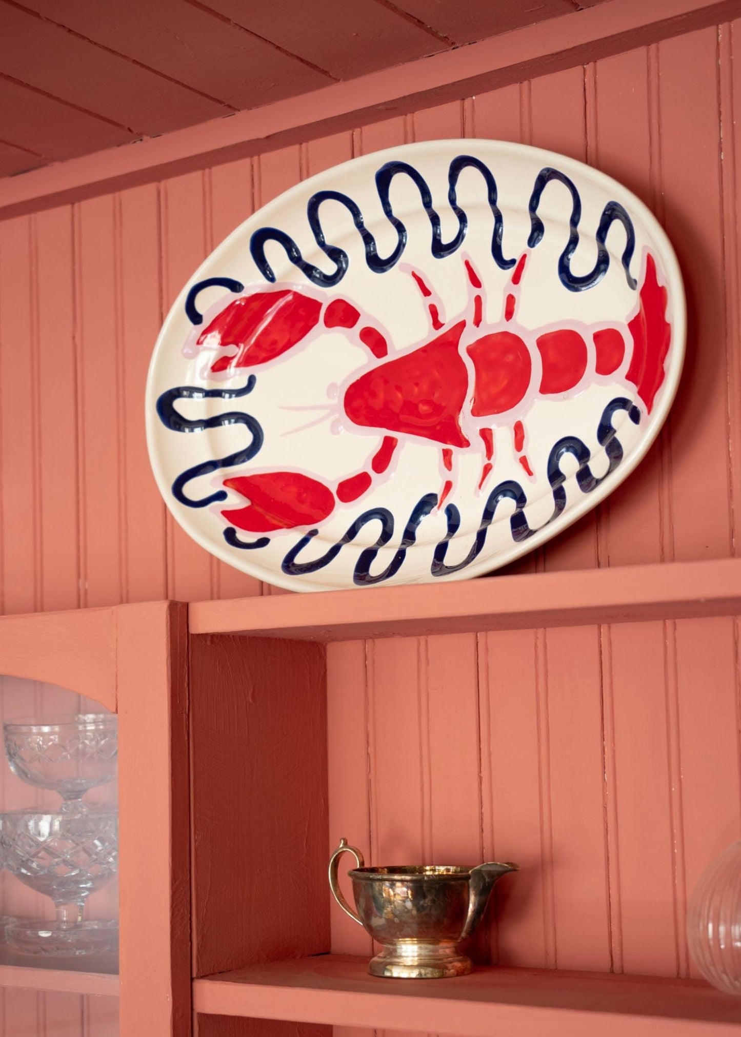 Lobster ceramic by Amuse La Bouche on pink cabinet