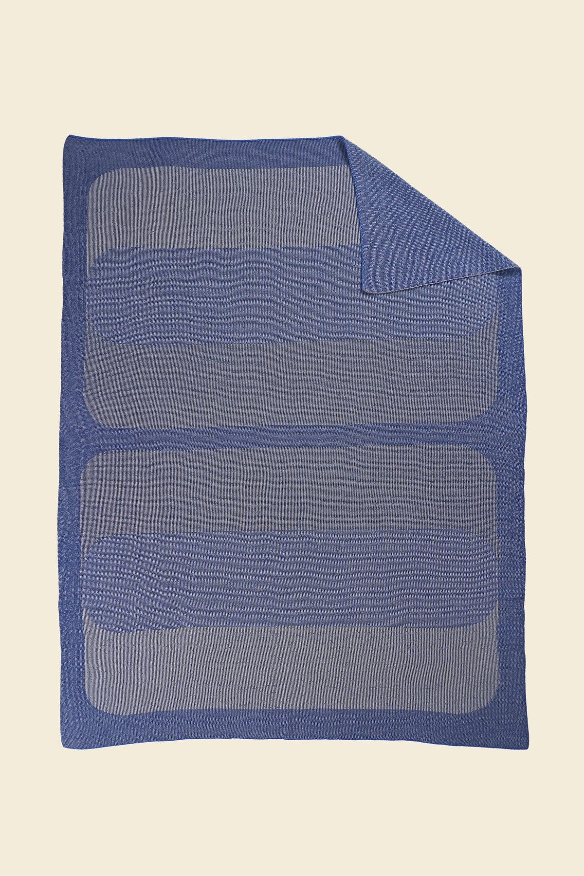 grey/blue knit blanket with flipped corner and with rectangles in merino wool and organic cotton