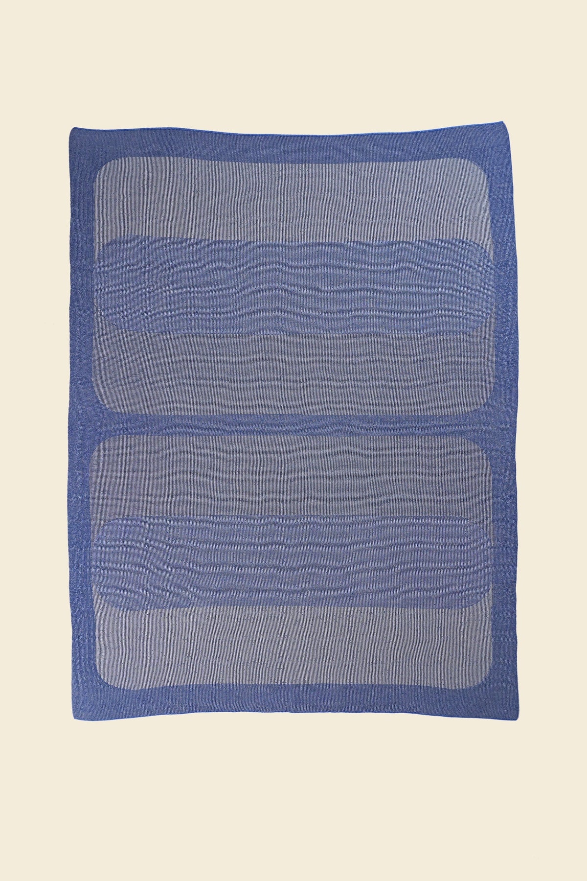 laid flat grey/blue knit blanket with rectangles in merino wool and organic cotton