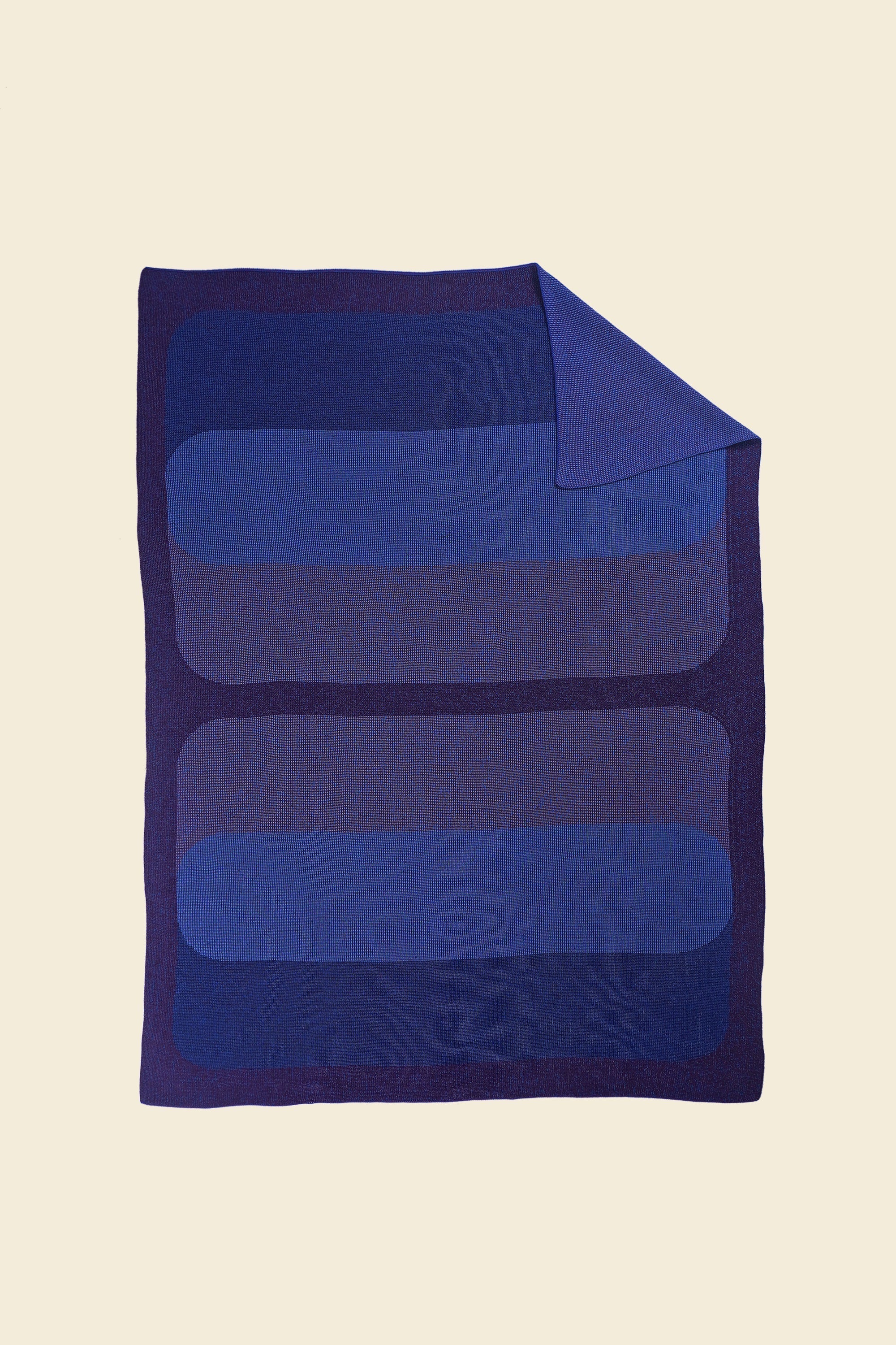 purple/blue knit blanket with flipped corner and with rectangles in merino wool and organic cotton