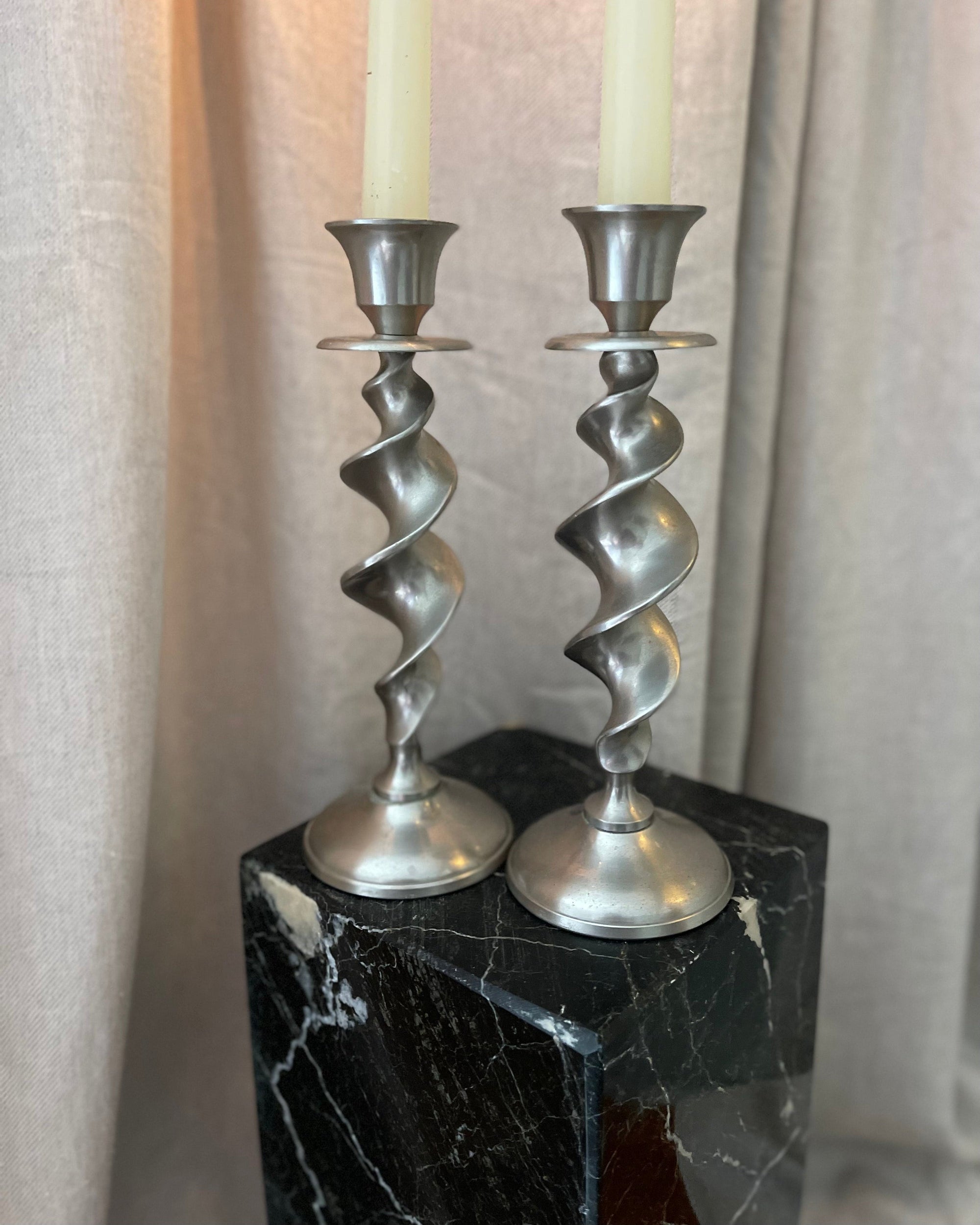 A Pair of Twisted Silvertone Candlesticks