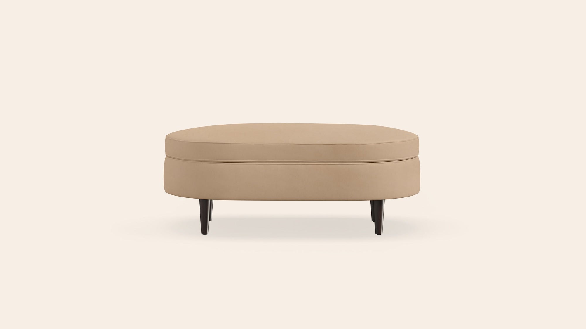 Beige ottoman centered on pale background