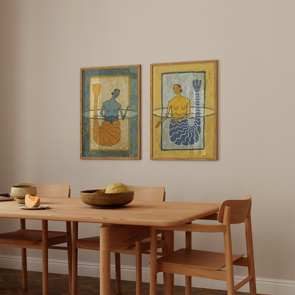 two Coastal giclée prints each featuring a single mermaid emerging from the water