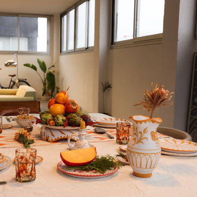 Dining table set with a thanksgiving theme in a room with a bicycle and plants. - lifestyle