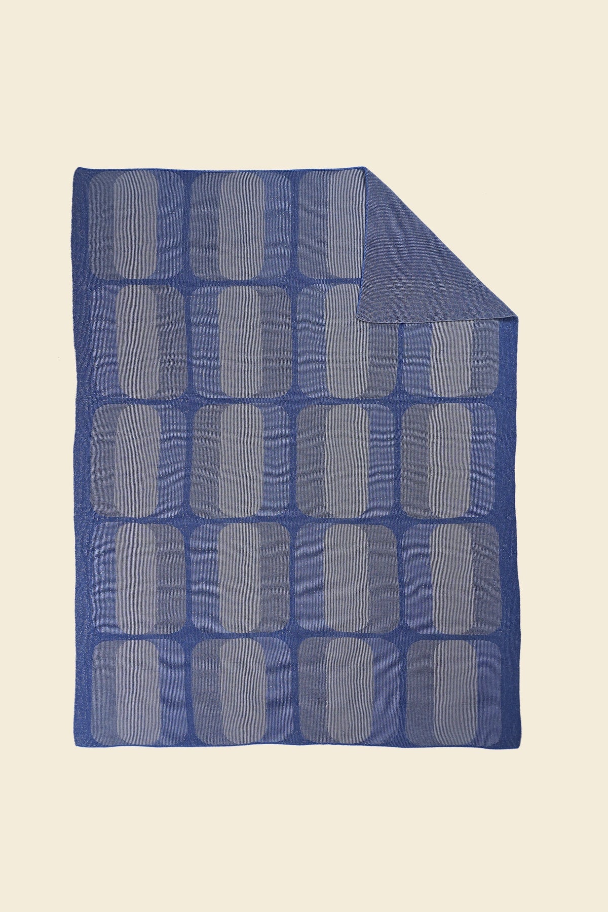 grey/blue geometric knit blanket with flipped corner in merino wool and organic cotton