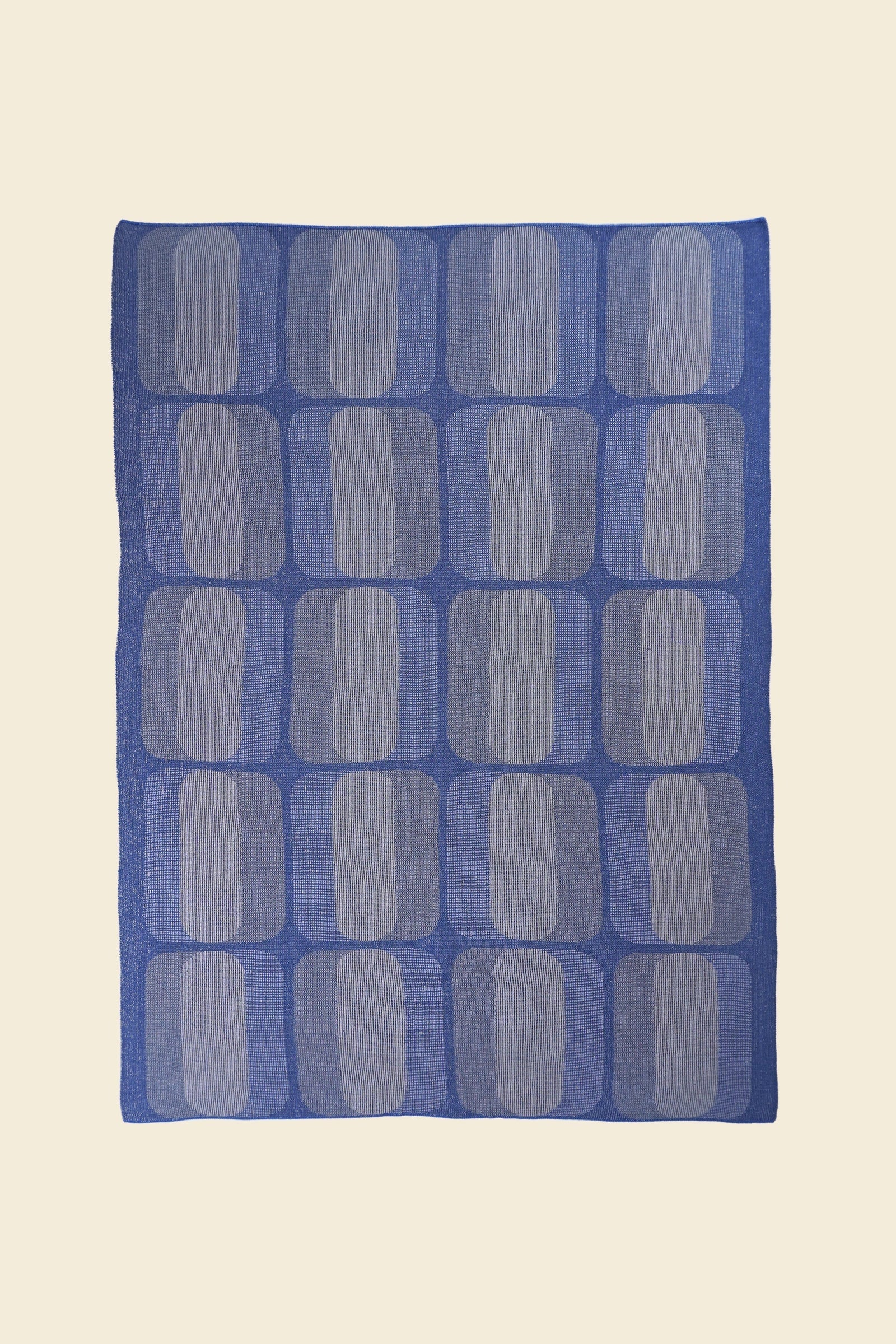 laid flat grey/blue geometric knit blanket in merino wool and organic cotton