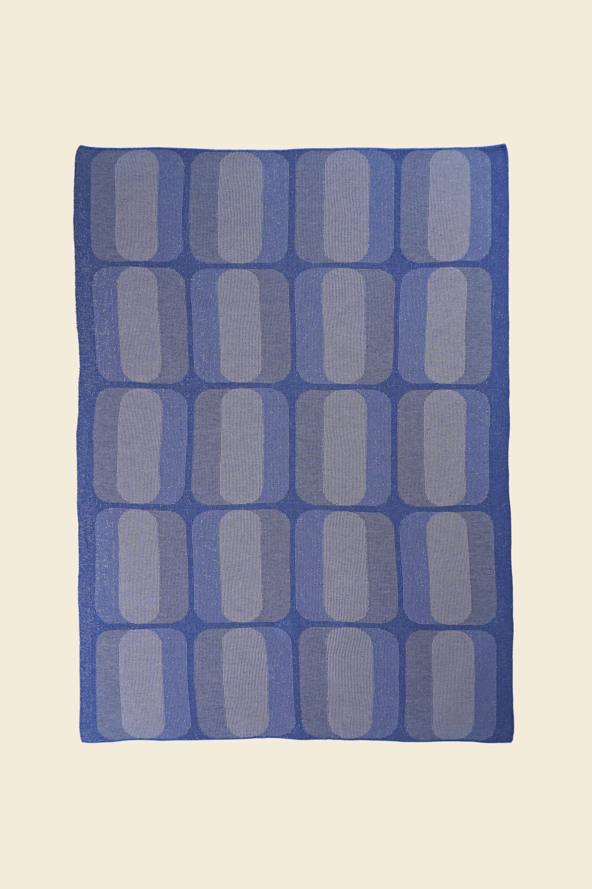 laid flat grey/blue geometric knit blanket in merino wool and organic cotton