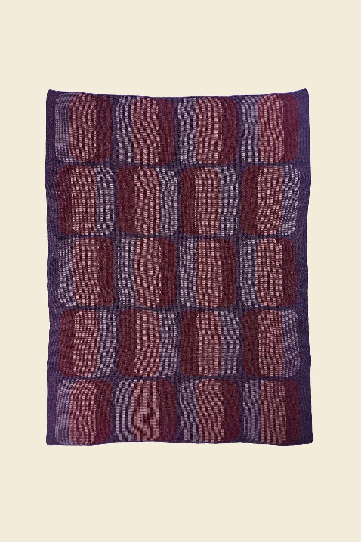 laid flat red/purple geometric knit blanket in merino wool and organic cotton