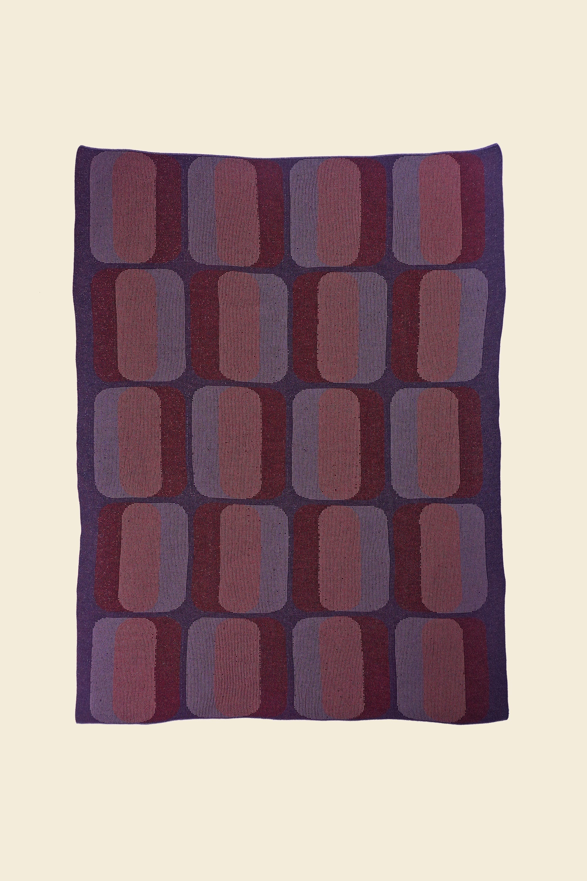 laid flat red/purple geometric knit blanket in merino wool and organic cotton