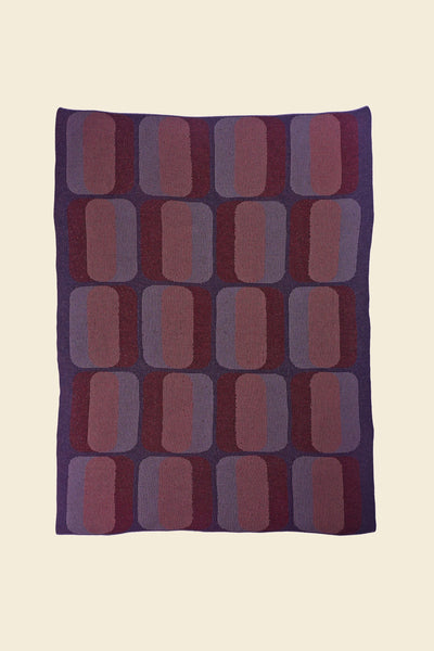 laid flat red/purple geometric knit blanket in merino wool and organic cotton