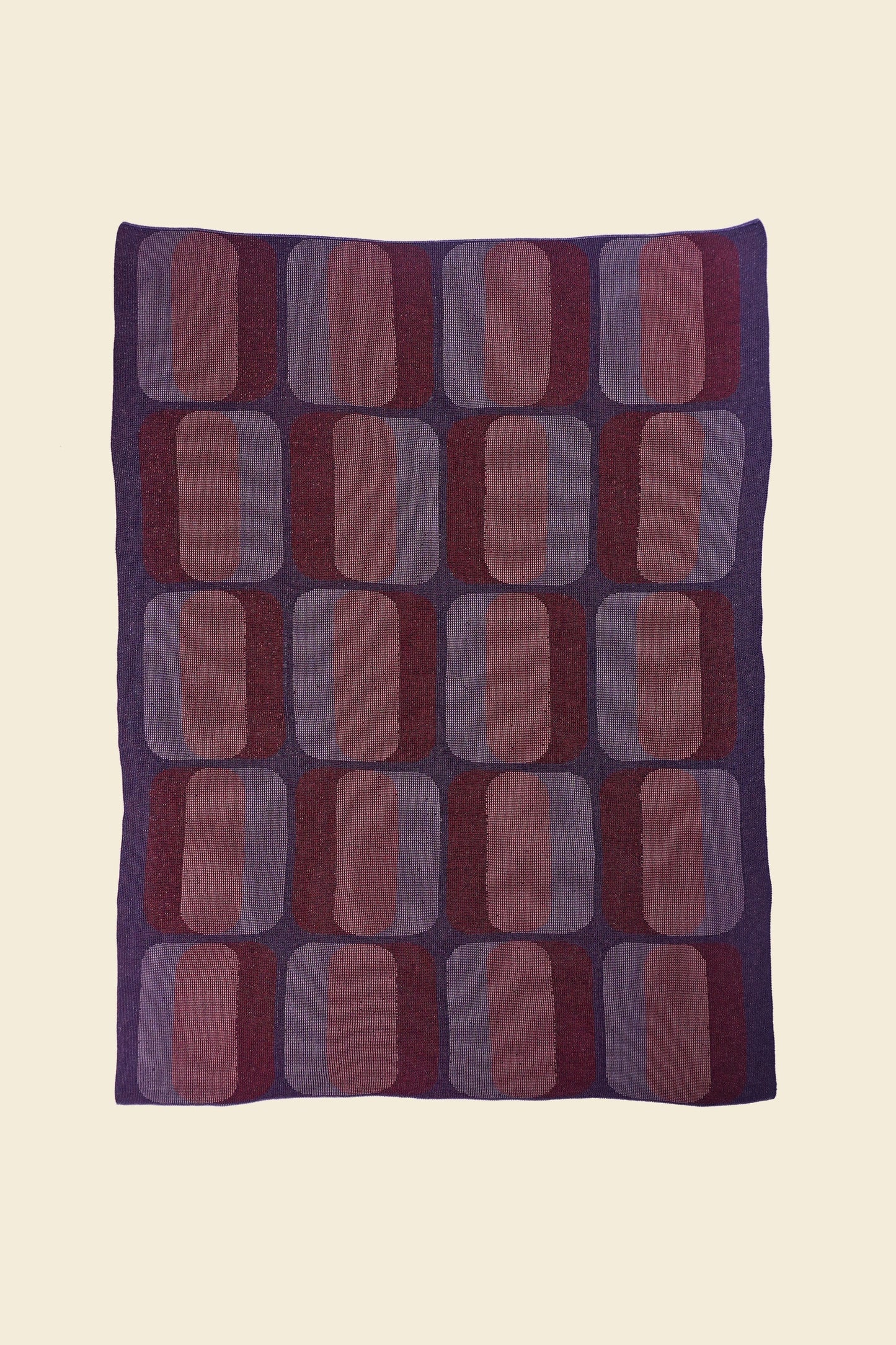 laid flat red/purple geometric knit blanket in merino wool and organic cotton