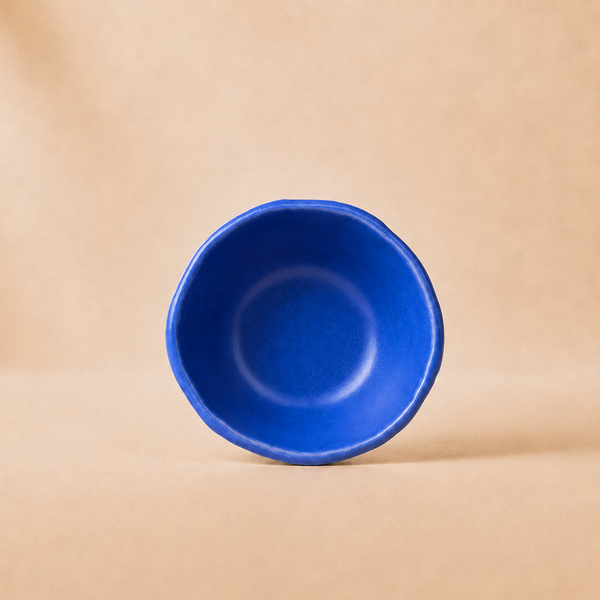 Blue ceramic bowl on a beige background