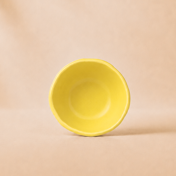 Yellow bowl on a beige background