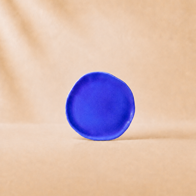 Blue ceramic plate on a beige background