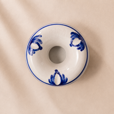 Ceramic donut-shaped dish with blue patterns on a beige background