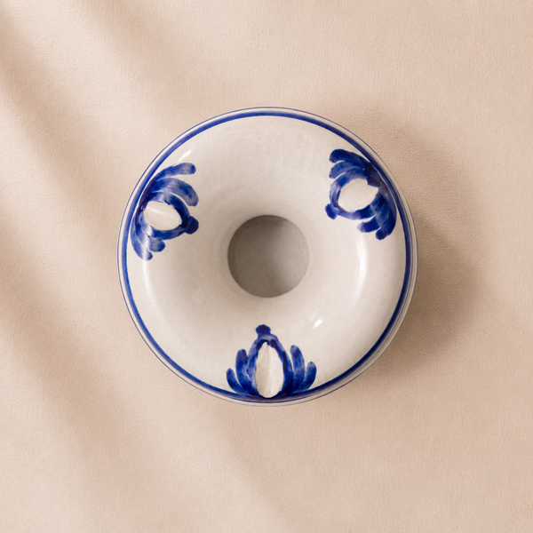 Ceramic donut-shaped dish with blue patterns on a beige background