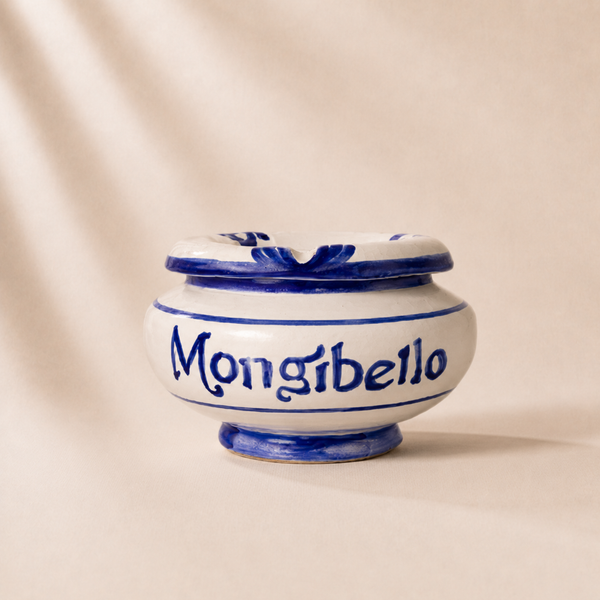 Ceramic jar with blue accents and 'Mongibello' branding on a beige background