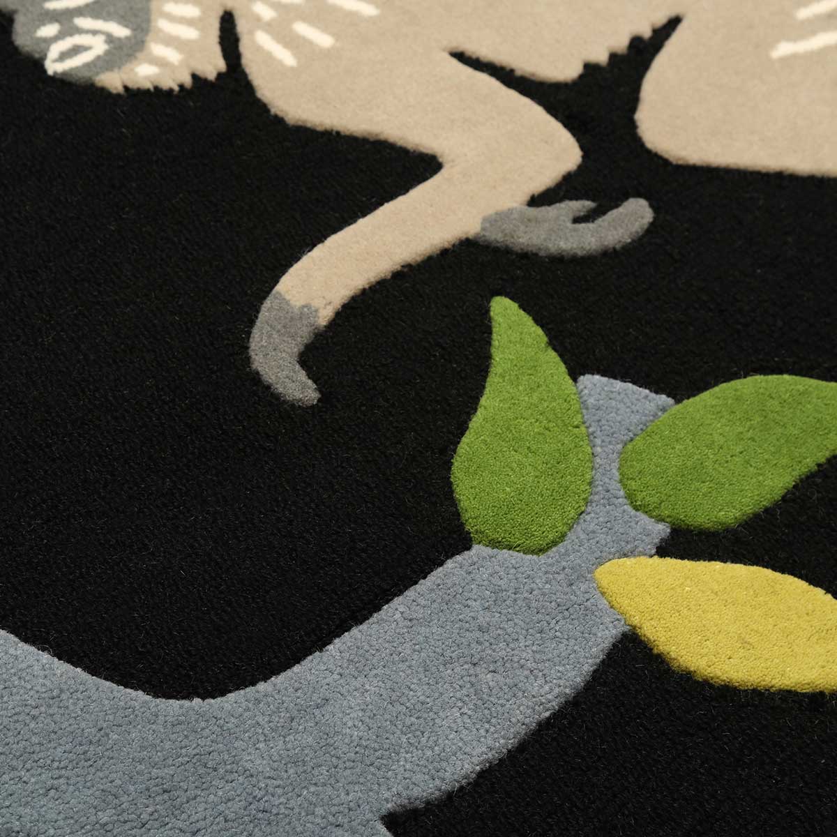 Detail of Langur Monkey rug hand tufted in wool with low loop pile and high cut pile motifs.
