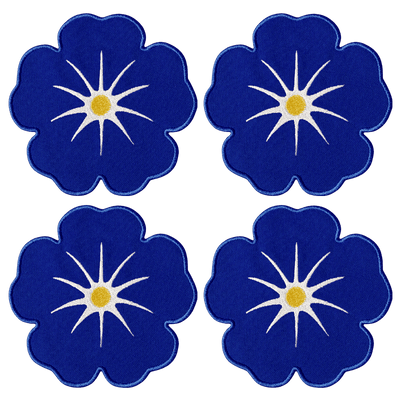 Octaevo Morning Glory Coasters (set of 4) feature blue florals with star centers and yellow dots on linen-cotton blend.