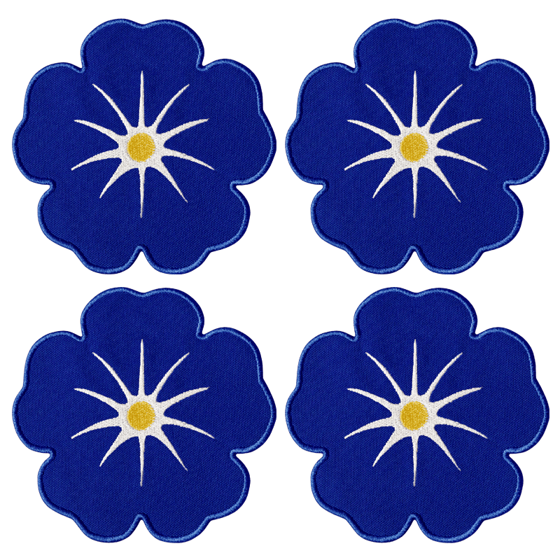 Octaevo Morning Glory Coasters (set of 4) feature blue florals with star centers and yellow dots on linen-cotton blend.