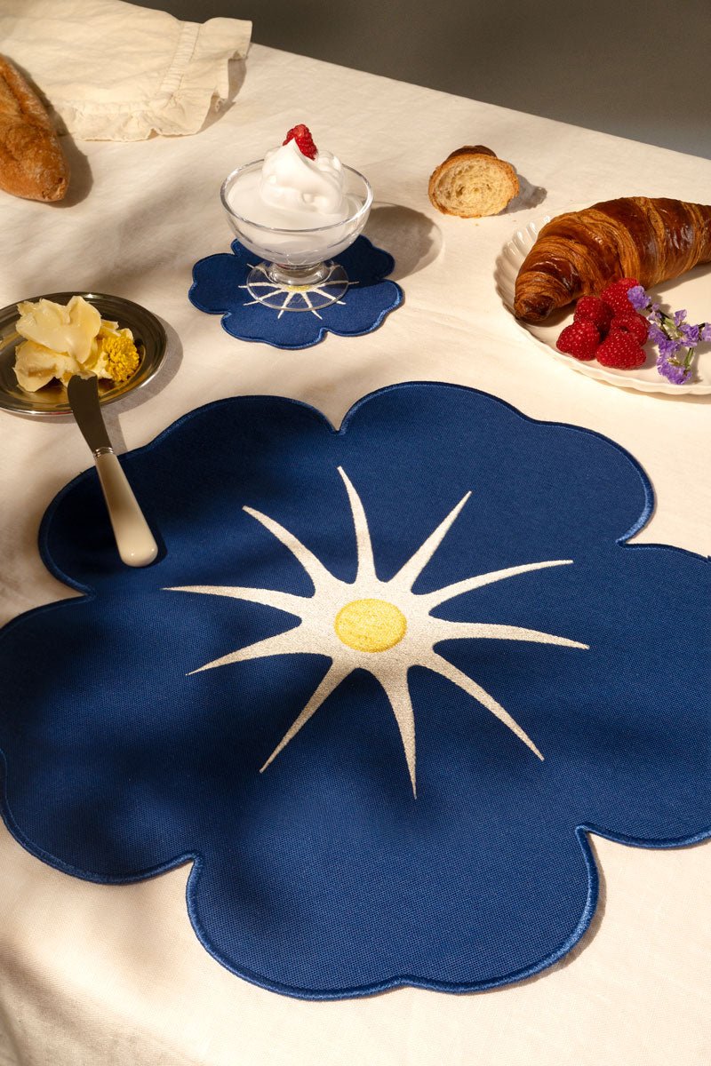 Octaevo Morning Glory Placemats (Set of 2) on a breakfast table with croissant, butter, raspberries, and dessert.