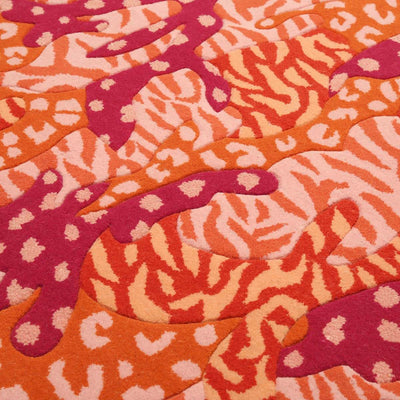 Detail of Orange Big Cat Camo Rug hand tufted and hand carved wool with camouflage and animal print patterns.