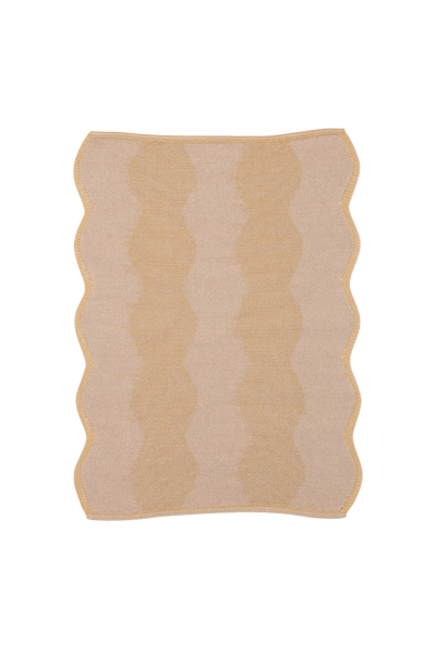 top view of beige and yellow knit organic cotton and hemp table mat with wavy pattern