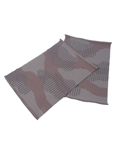 top view of beige knit organic cotton table mat with abstract design in pair