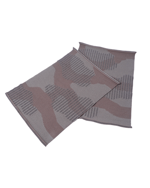 top view of beige knit organic cotton table mat with abstract design in pair