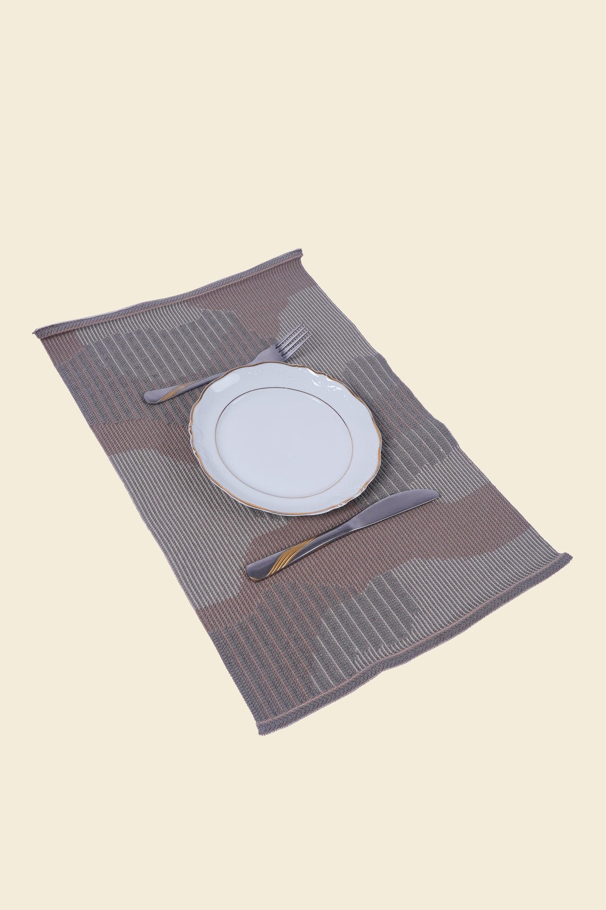 top side view of beige knit organic cotton table mat with abstract design