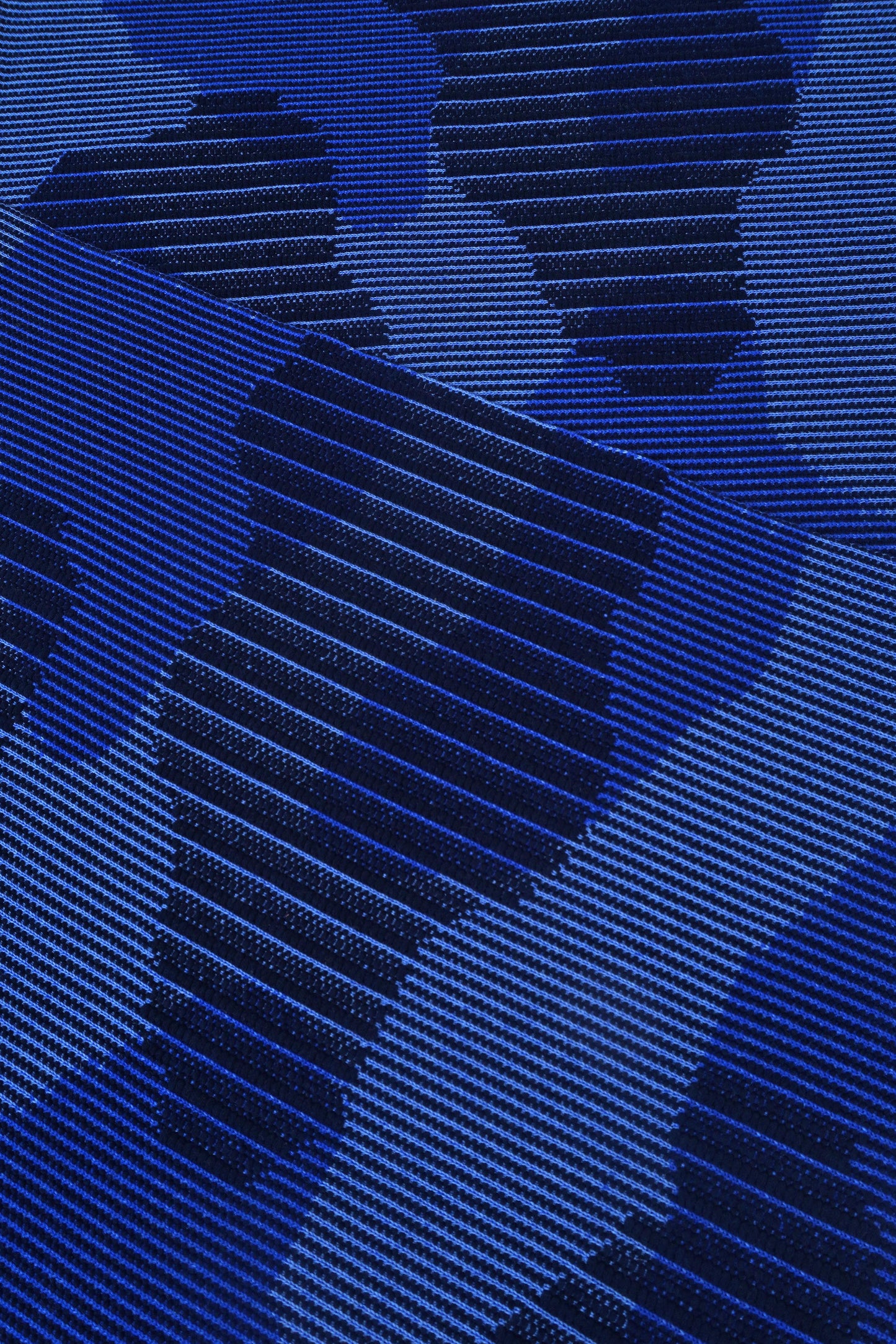 close-up of blue knit organic cotton table mat with abstract design