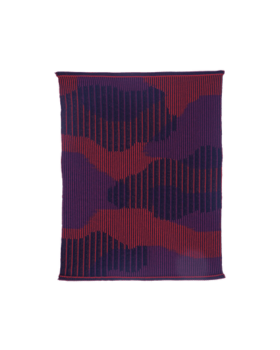 top view of red knit organic cotton table mat with abstract design