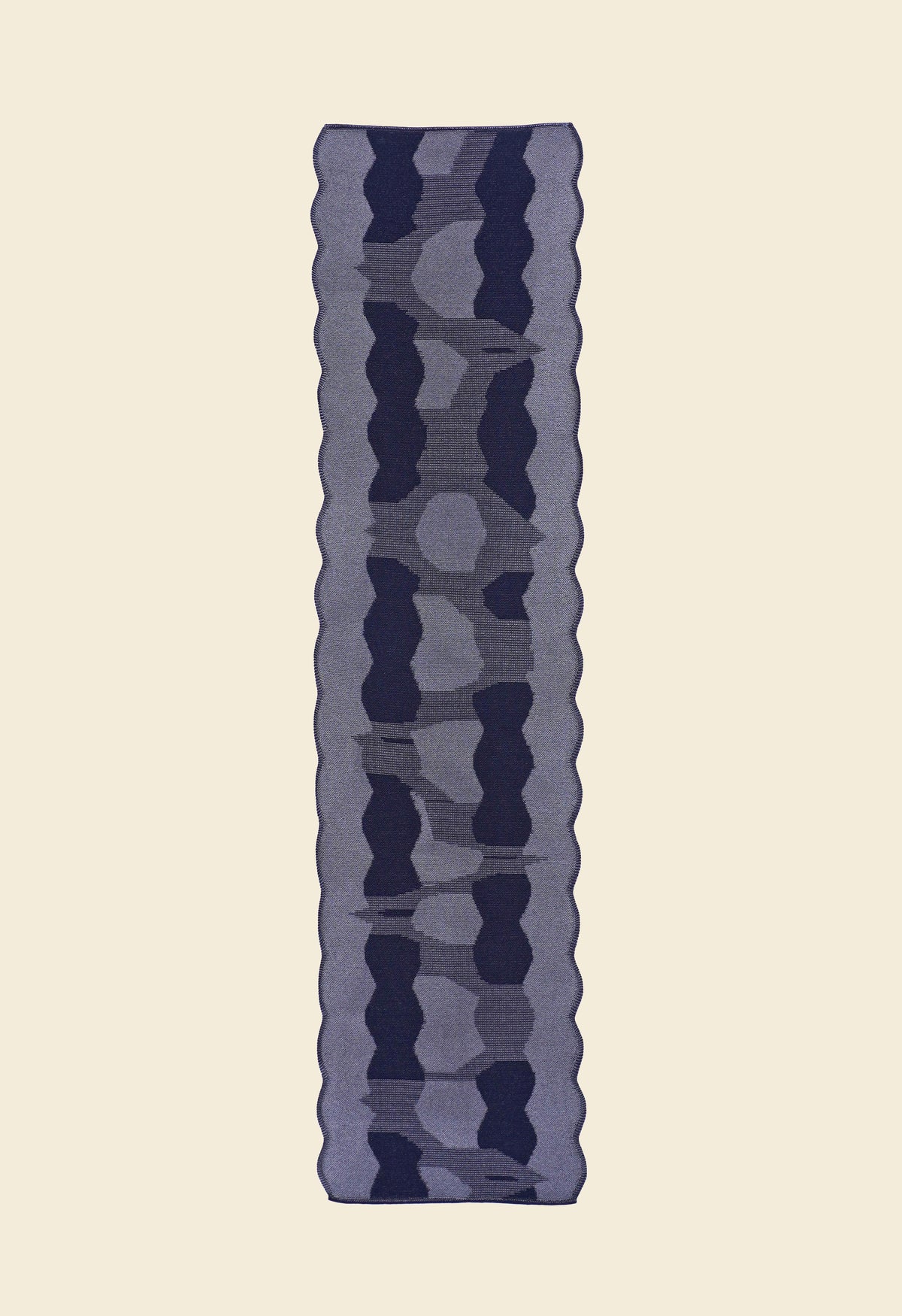 back side of grey knit organic cotton and viscose table runner with abstract pattern and wavy edges