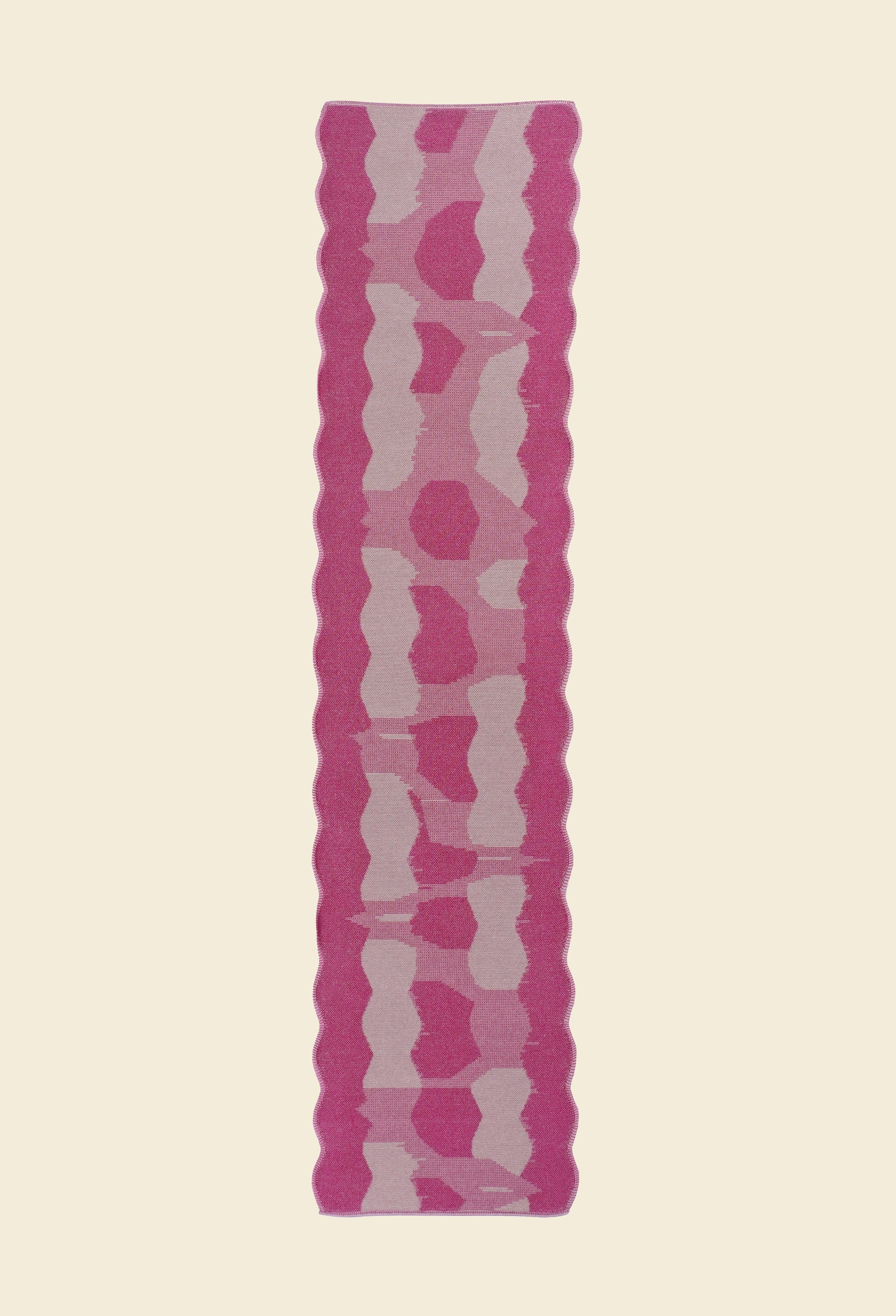 back top view of pink knit organic cotton and viscose table runner with abstract pattern and wavy edges